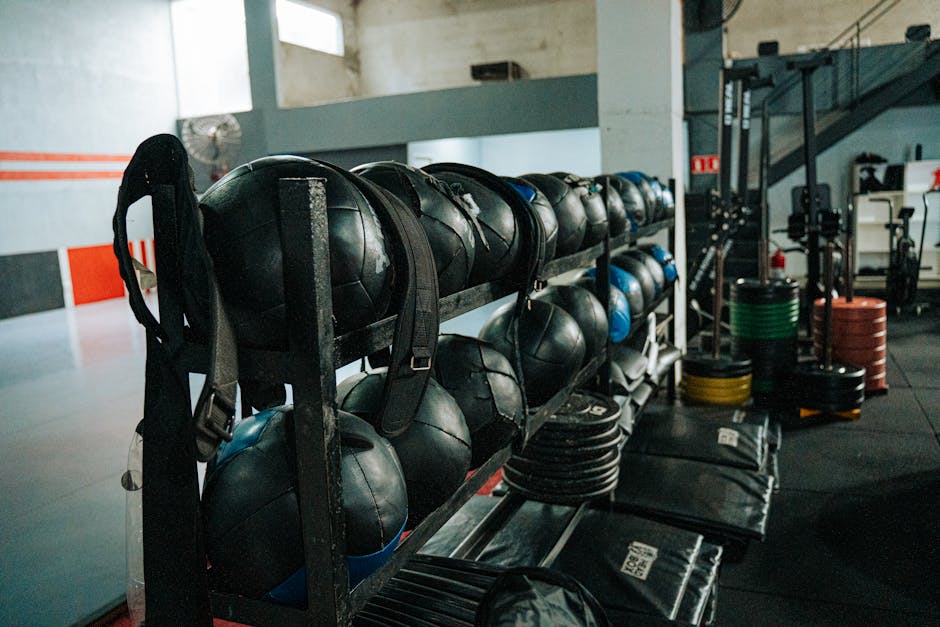 Well-equipped indoor gym featuring kettlebells, weights, and workout gear.