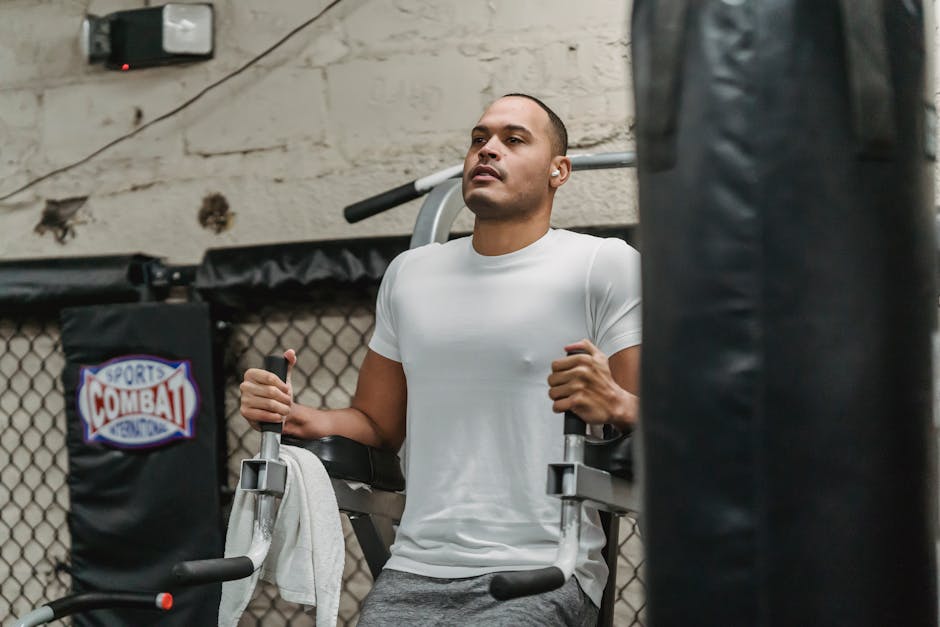 Focused sportsman doing knee to chest exercise
