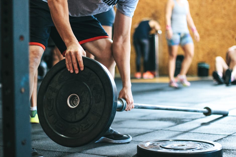 Focused weightlifting session in a gym with diverse athletes participating