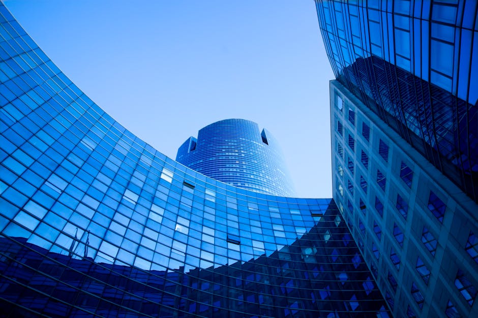 Stunning view of modern skyscraper with reflective glass panels under a clear blue sky