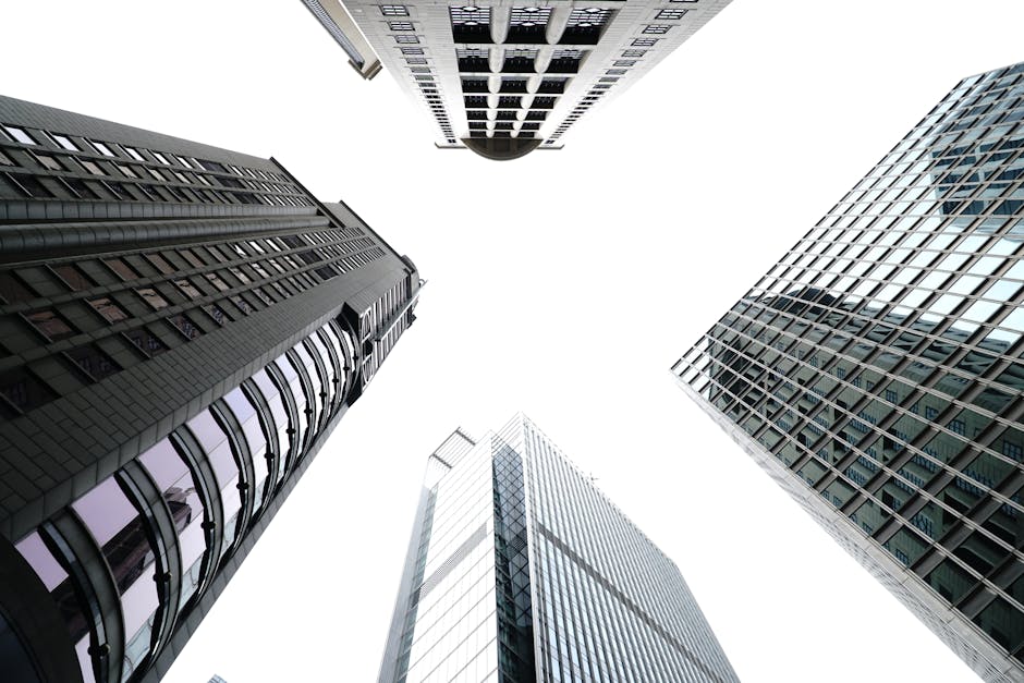 Low angle view of skyscrapers against a bright sky showcasing modern architecture