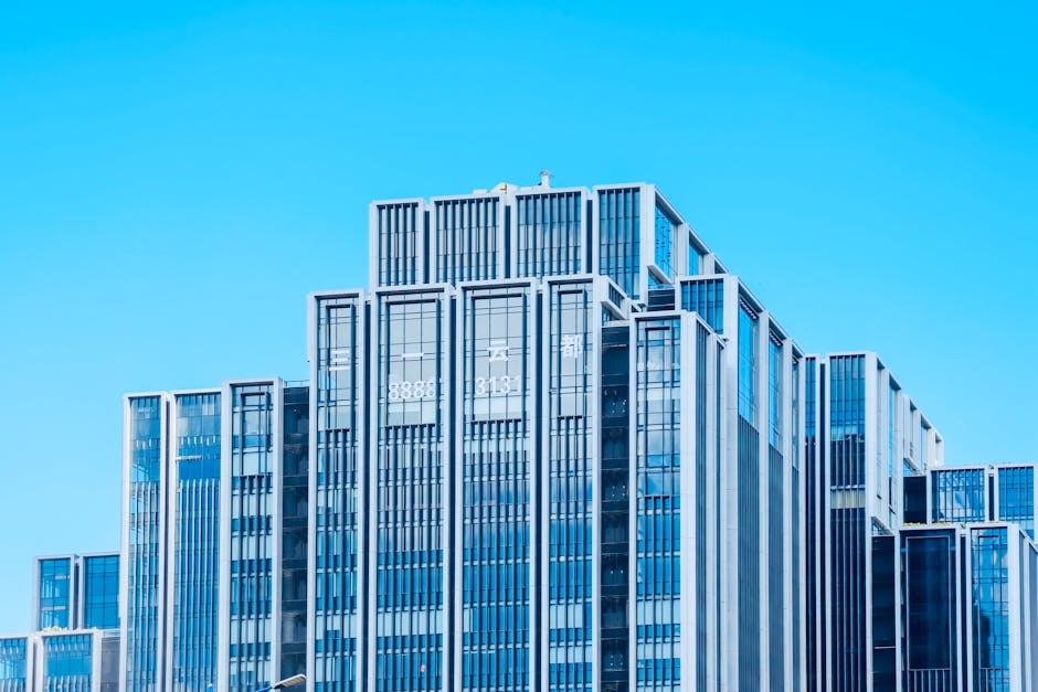 Contemporary glass building under bright daylight with clear blue sky backdrop