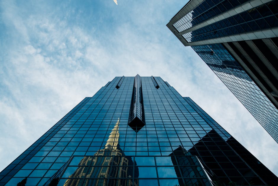 Low angle view of a modern skyscraper with reflective glass facade
